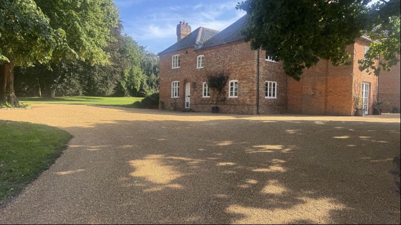 Farmyard re-surfaced Hot tar and golden gravel 
